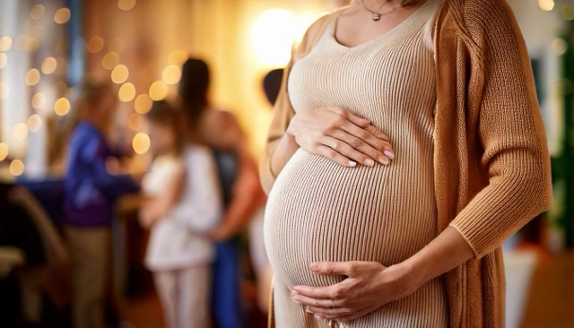 pregnant woman at baby shower with gifts